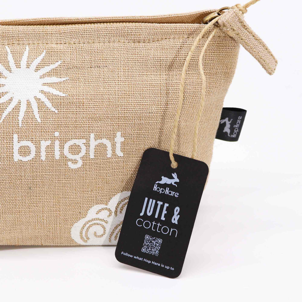 A beige jute pouch with an 'I am bright' affirmation in white. 