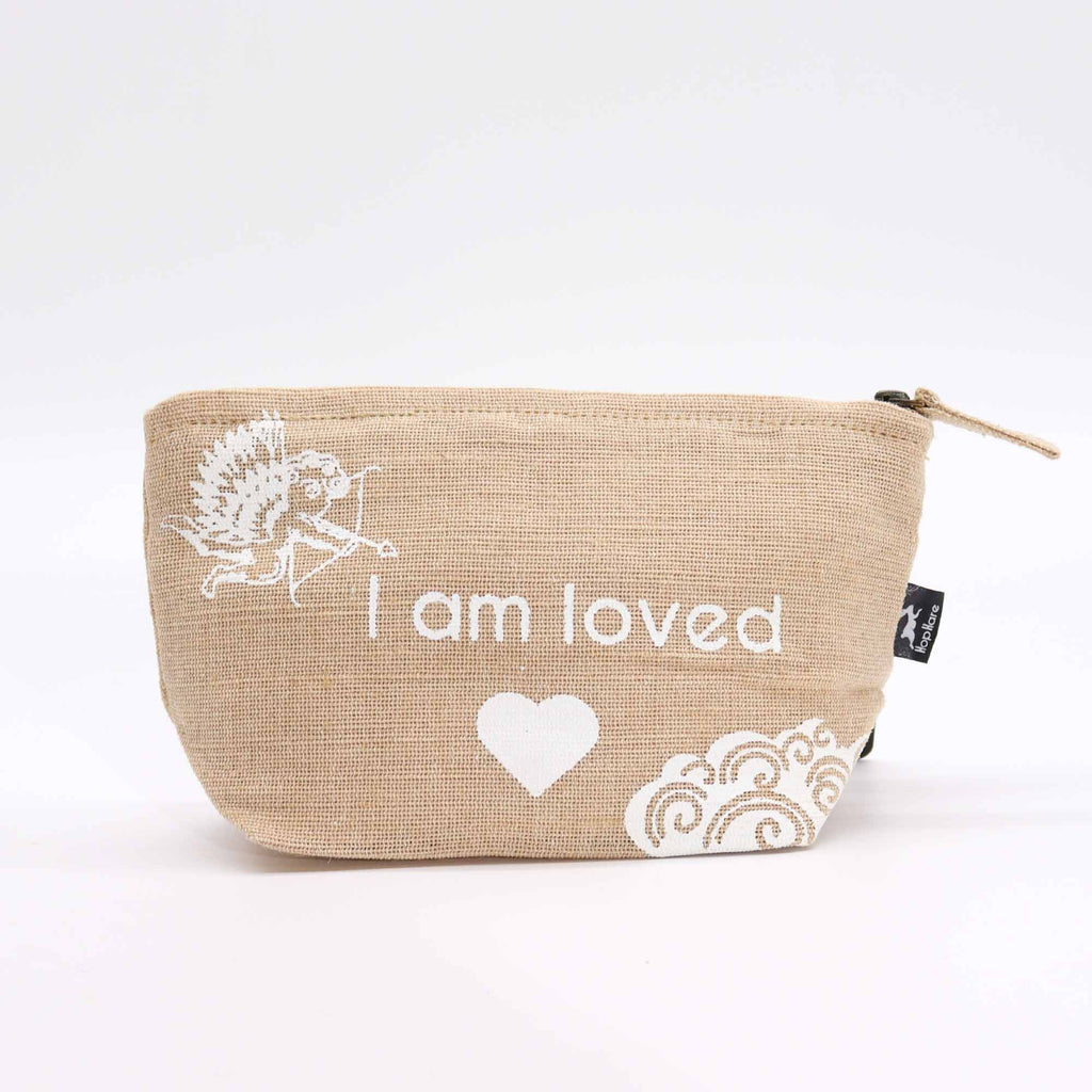 A beige jute pouch with an 'I am loved' affirmation in white. 