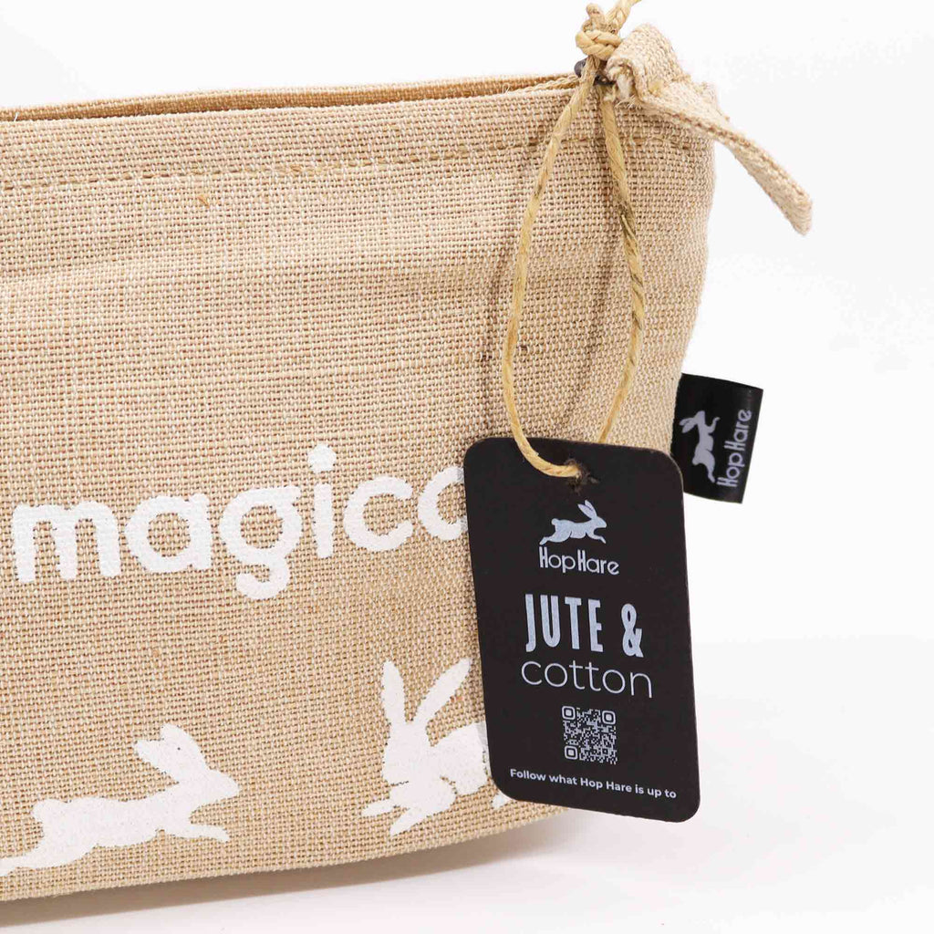 A beige jute pouch with an 'I am magical' affirmation in white. 