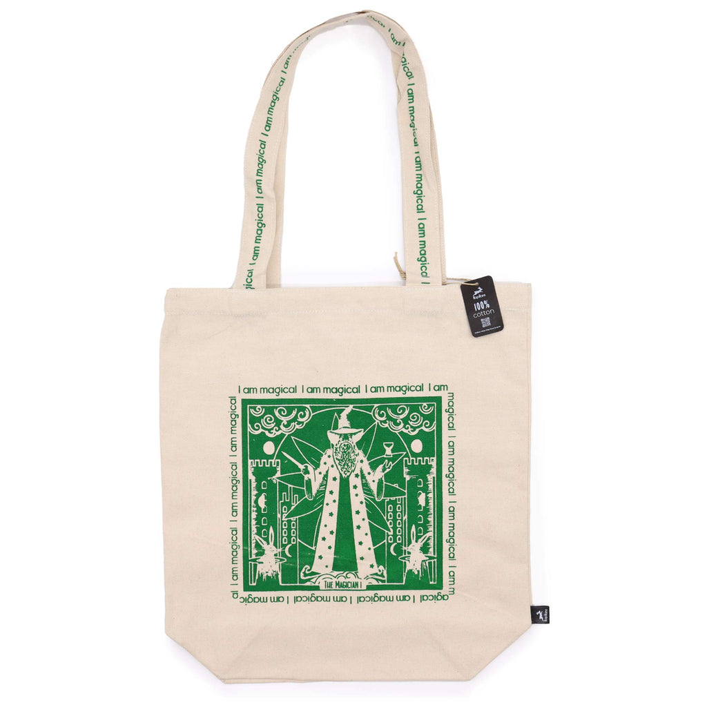 Tote bag with green motif which is of a "magician" standing in front of a castle with the affirmation "I am magical" repeated around the motif. 