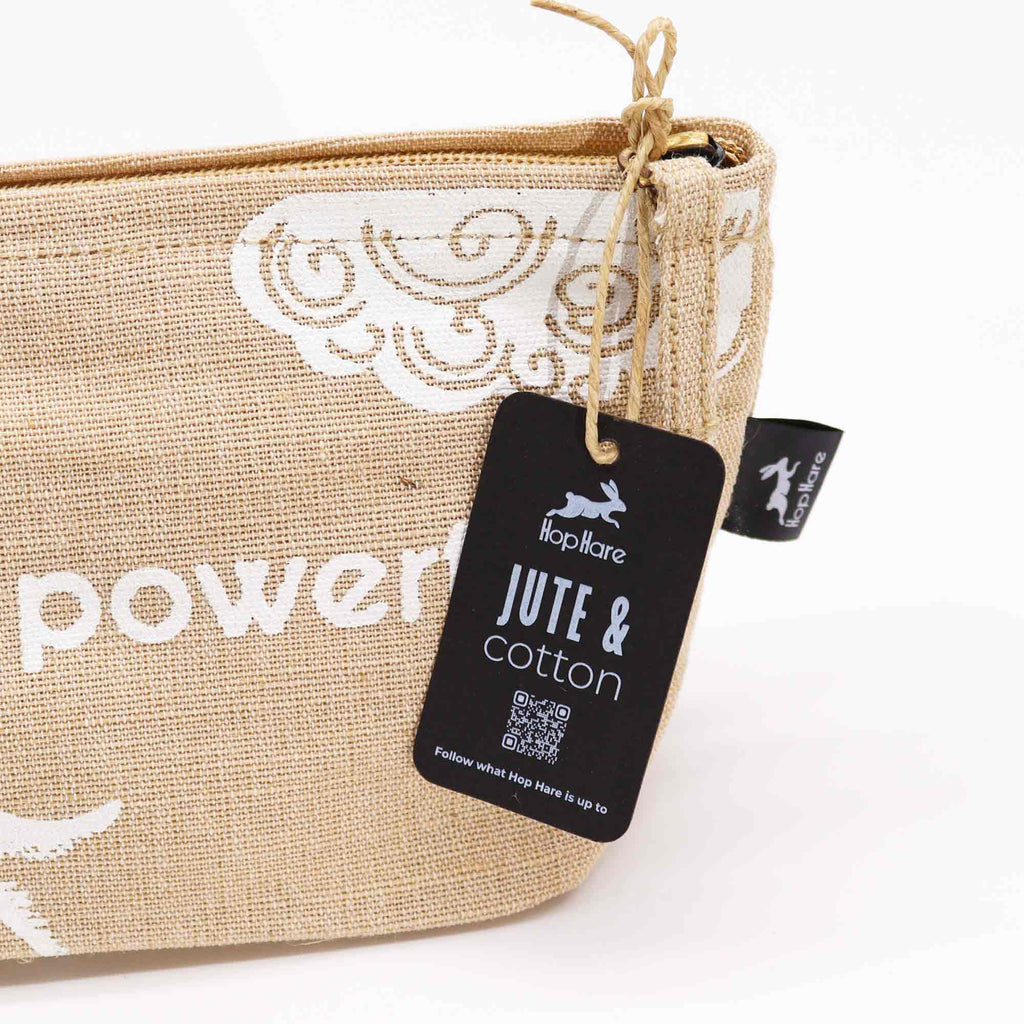 A beige jute pouch with an 'I am powerful' affirmation in white. 
