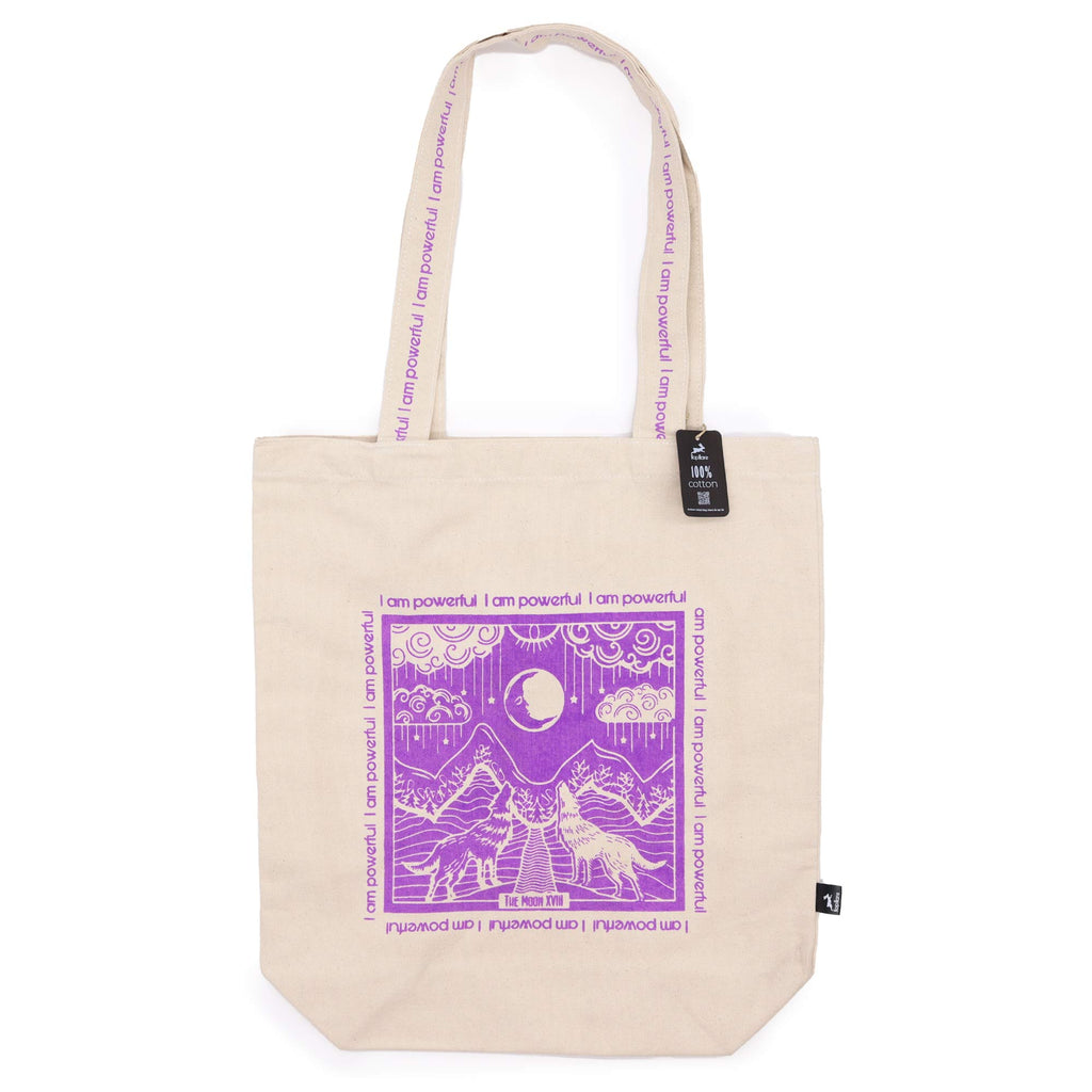 Tote bag with purple motif which is of wolves howling to the moon with the affirmation "I am powerful" repeated around the motif. 