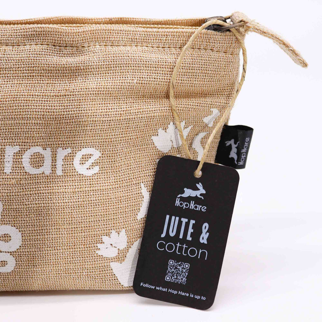A beige jute pouch with an 'I am rare' affirmation in white. 