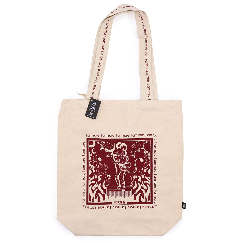 Tote bag with red motif which is of a "devil" with the affirmation "I am rare" repeated around the motif. 