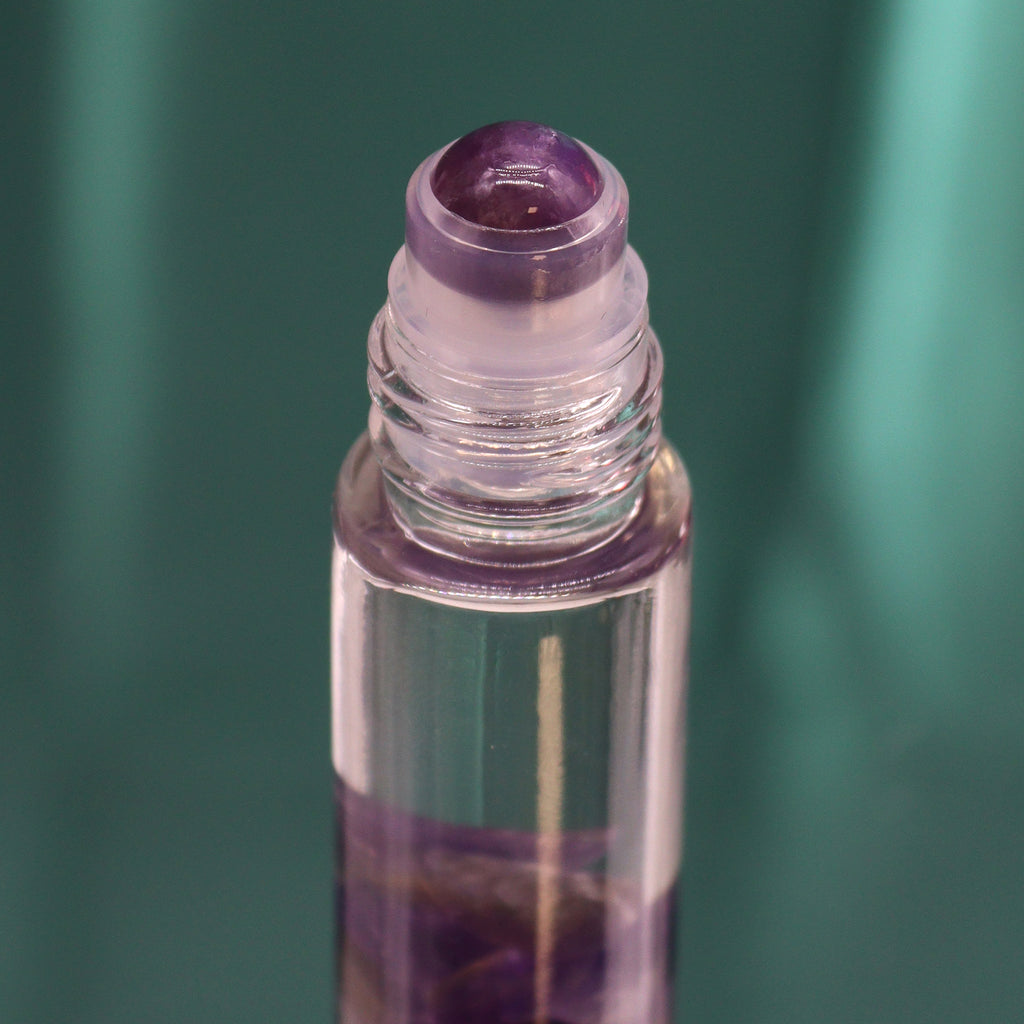 A close up of a purple roll-on essential oil bottle 