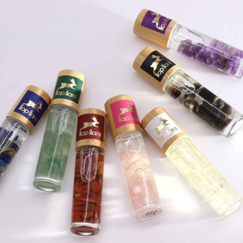 A selection of colourful essential oil roll on glass tubes with various crystals 