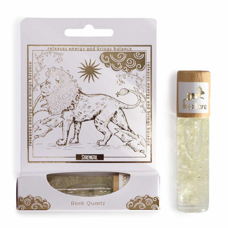 An essential oil gemstone roll-on bottle with a gold-printed tarot card, alongside its packaging. The roll-on bottle is clear, and the packaging features a line art design with a lion and a sun.