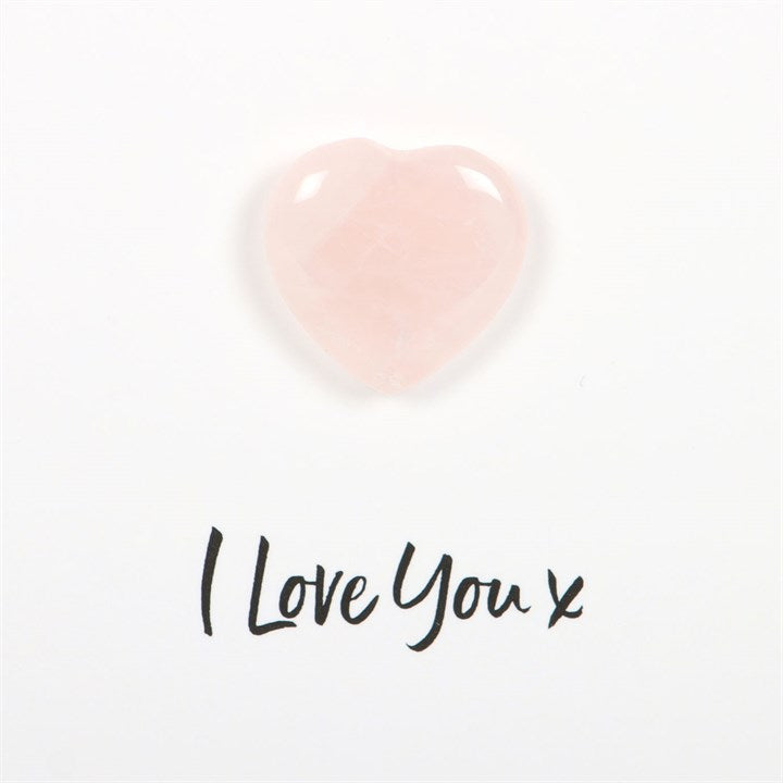 Font stating "I love you x" on a white background with a rose quartz crystal heart above it.
