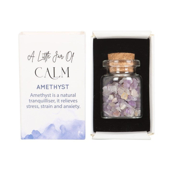 A white matchbox-style gift box labelled 'A Little Jar of Calm' with a small glass jar filled with purple amethyst crystal chips inside.