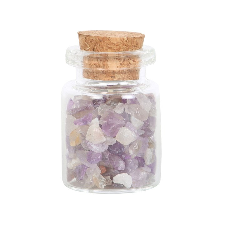 A small glass jar filled with purple amethyst crystal chips inside.
