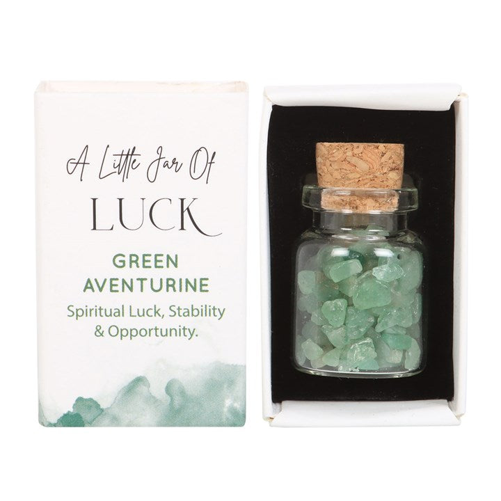 A white matchbox-style gift box labelled 'A Little Jar of Luck' with a small glass jar filled with green aventurine crystal chips inside.