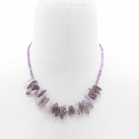 A purple longstone Amethyst necklace displayed on a mannequin bust.