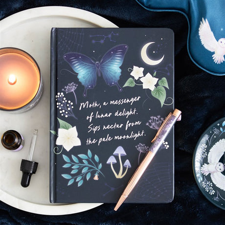 A notebook on a decorative surface reads "Moth, a messenger of lunar delight. Sips nectar from the pale moonlight." in cursive font.