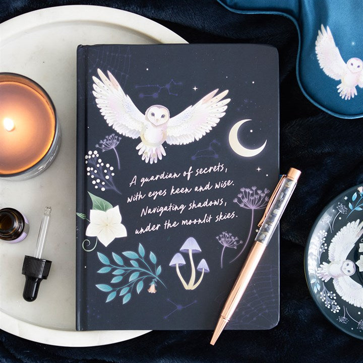 A notebook on a decorative surface reads "A guardian of secrets, with eyes keen and wise. Navigating shadows under the moonlit skies." in cursive font.