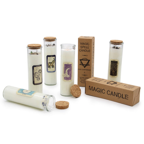 A collection of Magic Spell Candles in various designs, with gemstones embedded in them, displayed alongside their packaging boxes. The candles are made of soy wax and have glass containers with cork stoppers.