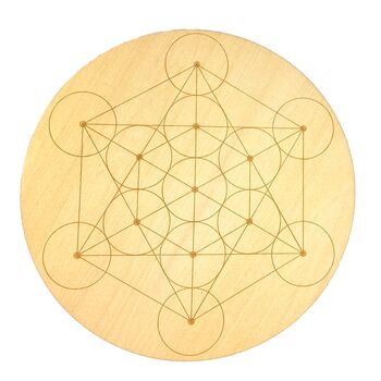 A wooden crystal grid with sacred geometric patterns, specifically a Metatron's Cube design.