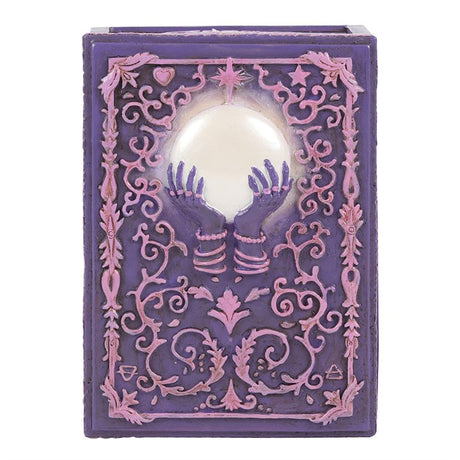 A pink and purple resin storage box with a mystical hand and crystal ball design, featuring raised filigree details.