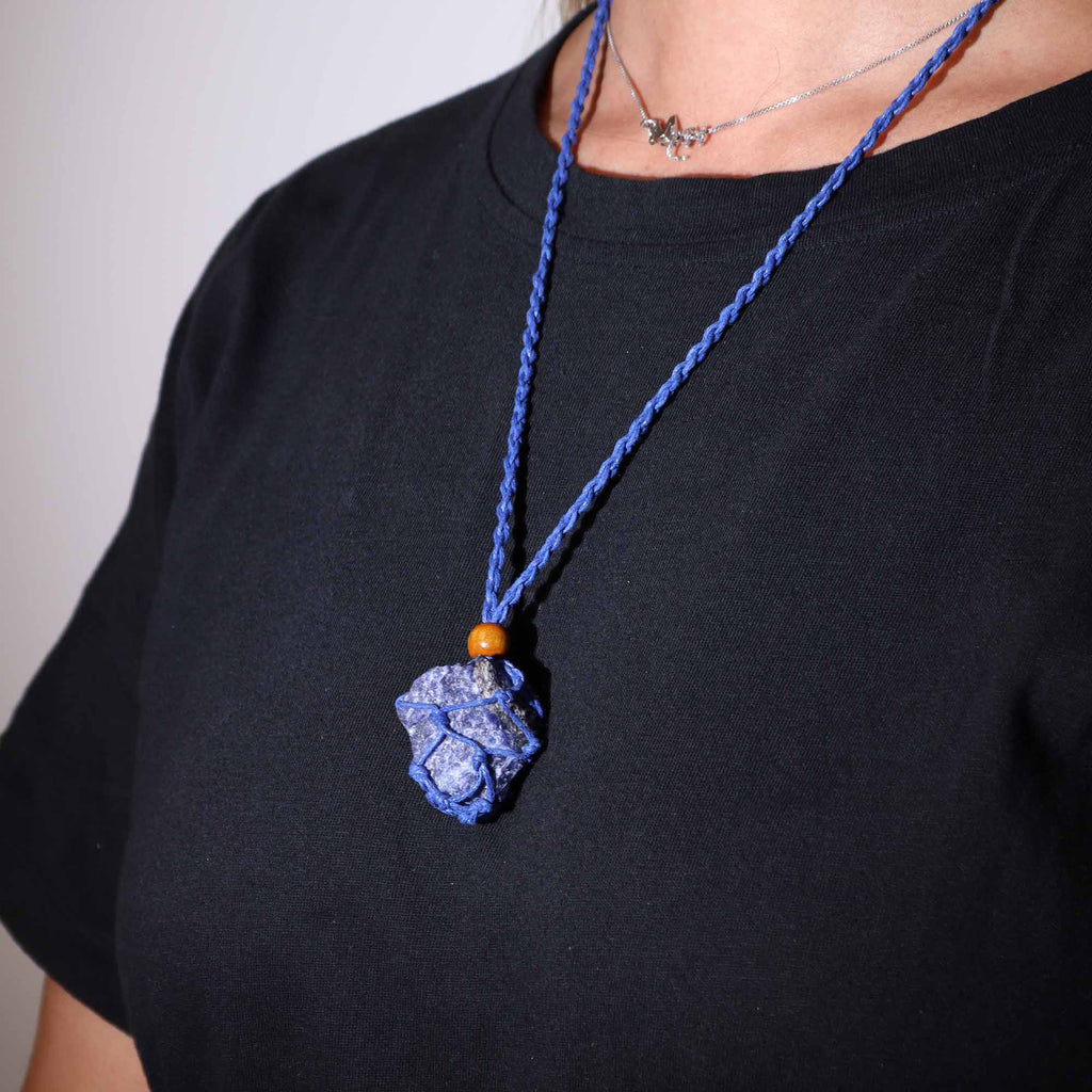 A blue-coloured crystal cord necklace with an example crystal inside