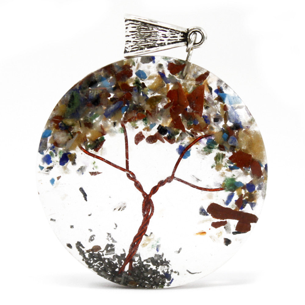 An Orgonite Tree of Life power pendant against a white background with varying colours