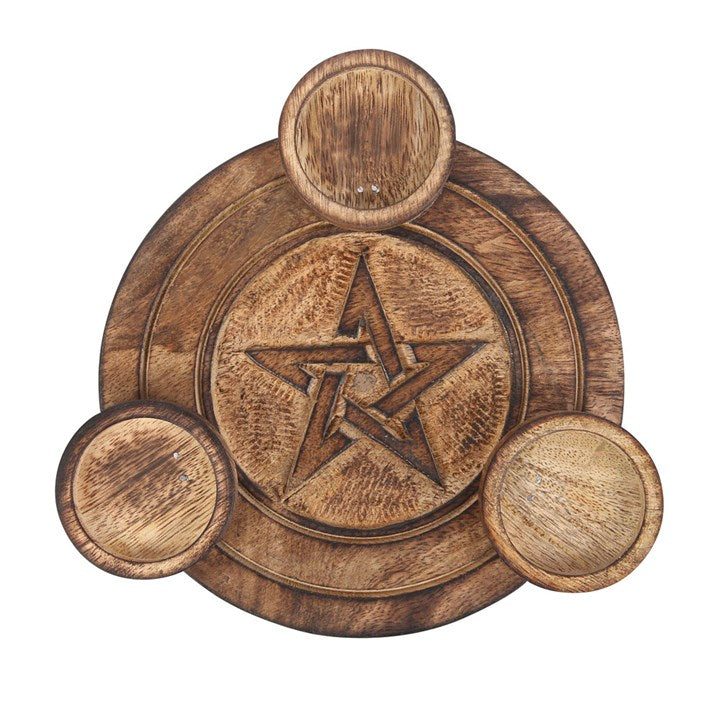 A round wooden tea light holder with an engraved pentagram design with space for three tea lights. Sits against a white background