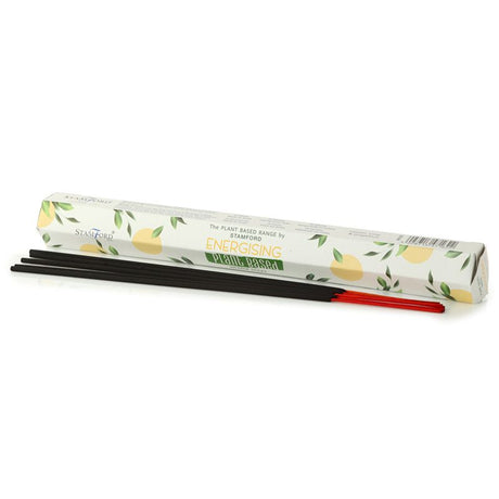 A white tube of "Energising" incense sticks next to dark and red coloured incense sticks. 