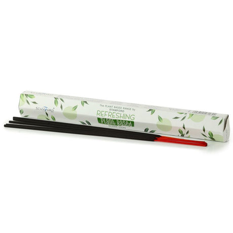 A white tube of "Refreshing" incense sticks next to dark and red coloured incense sticks. 