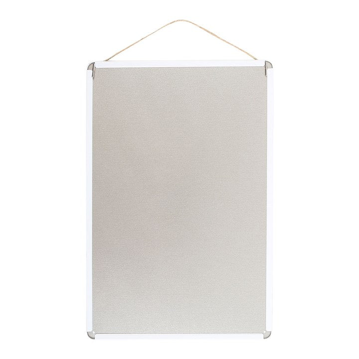 The back of a tin sign which is plain white.