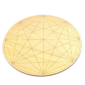 A wooden crystal grid with sacred geometric pattern