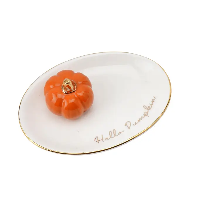 White oval dish with a small orange pumpkin decoration and 'Hello Pumpkin' text on a white background