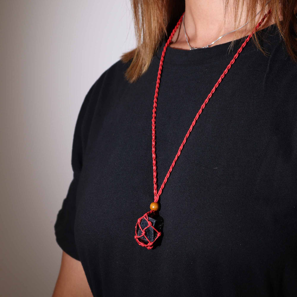 A red-coloured crystal cord necklace with an example crystal inside