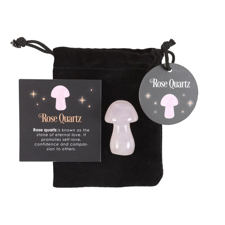 A Rose Quartz mushroom crystal, with a drawstring bag and a card that has 'Rose Quartz' text next to it.