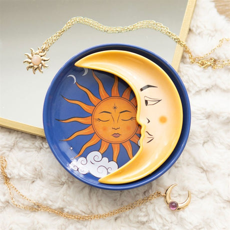 A two-piece ceramic stacking trinket dish featuring the sun as a round dish and the moon as a stackable crescent on top