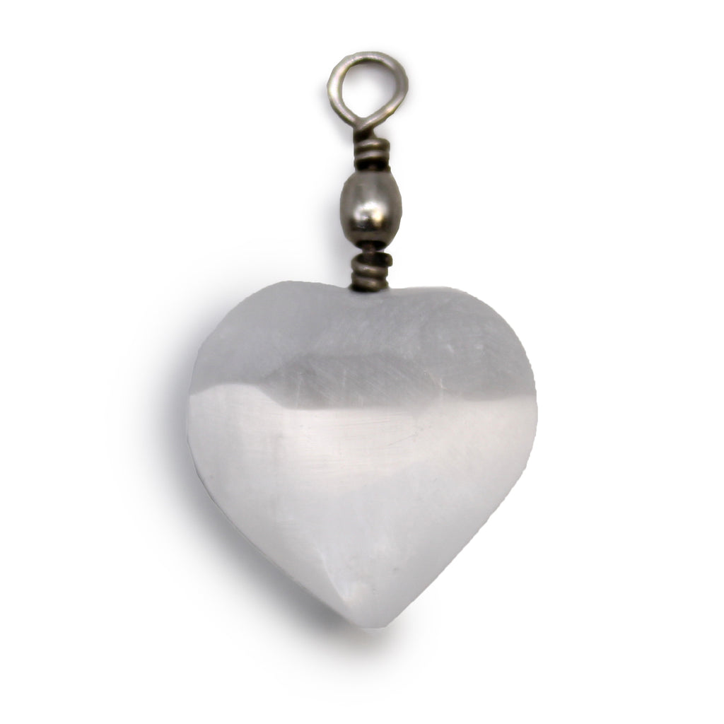 A close up of a Selenite heart pendant  against a white background
