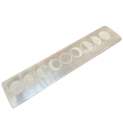 Selenite charging bar with moon phases design against a white background