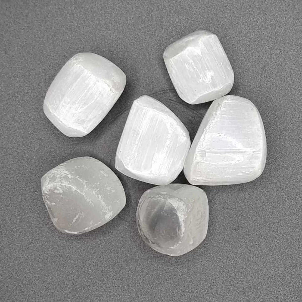 A picture of six Selenite tumblestones