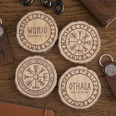 Wooden coasters with engraved Viking Norse symbols and text on a wooden surface