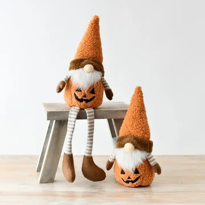 Two Halloween-themed gonks on a wooden surface with a white background