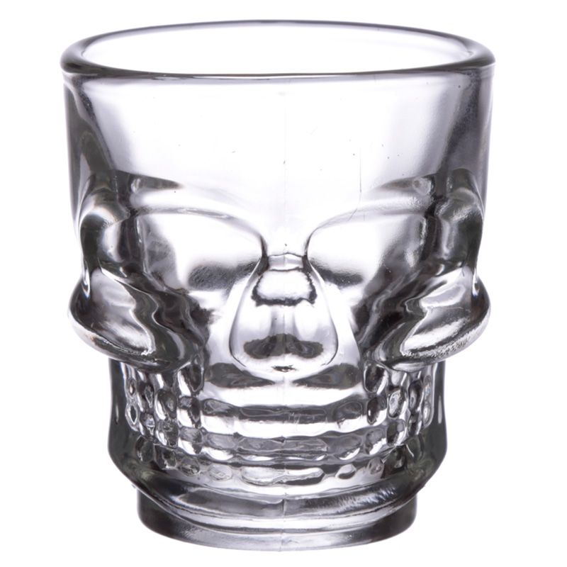 A skull themed shot glass from the front on a white background