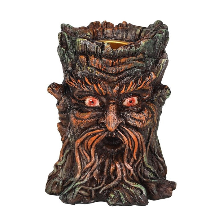 A brown resin Green Man backflow incense burner placed on a white surface