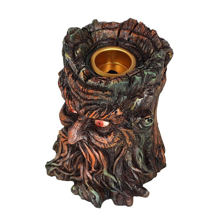 A brown resin Green Man backflow incense burner placed on a white surface