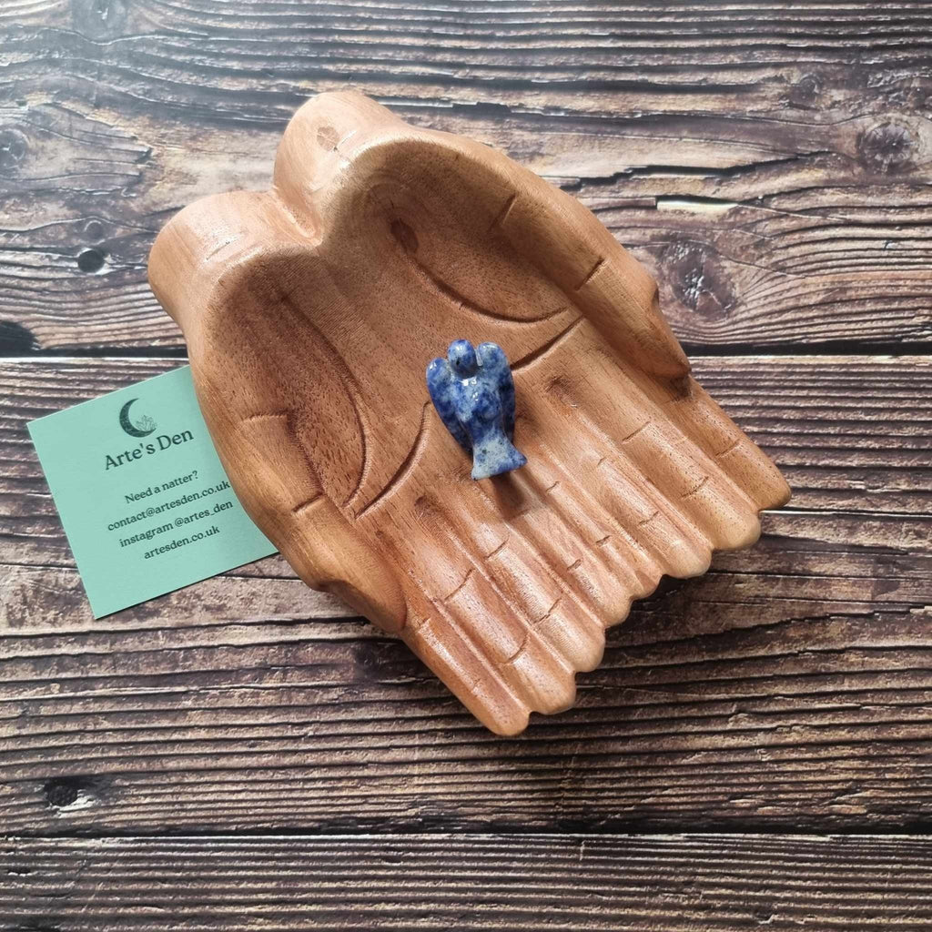 A blue crystal angel on a wooden backdrop 