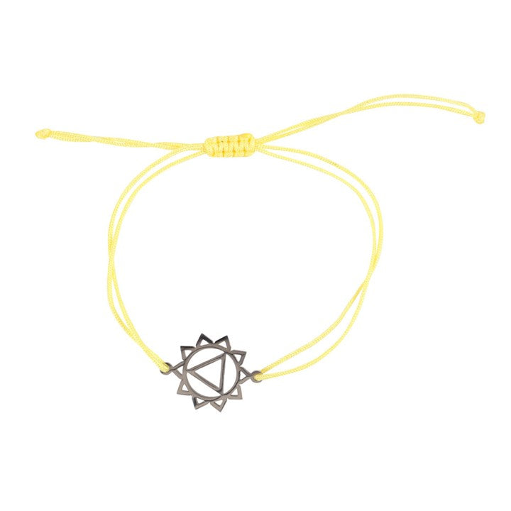 A Solar Plexus Chakra charm bracelet with a yellow band and a silver charm against a white background 