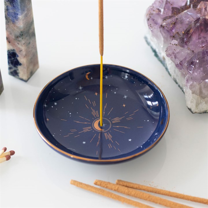 A blue celestial themed incense holder with incense stick 