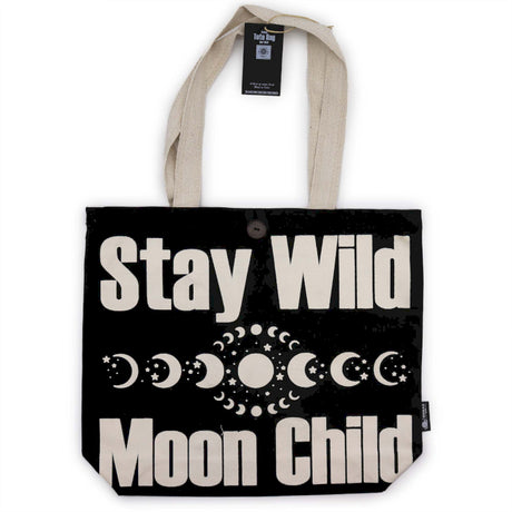 Tote bag with 'Stay Wild Moon Child' text and moon phases on a black background