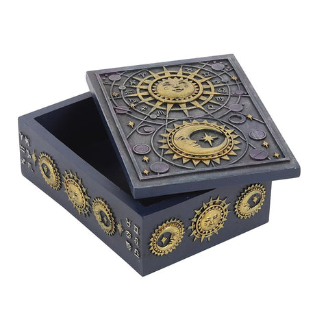 A dark blue sun, moon and zodiac themed resin storage box with the lid slightly ajar