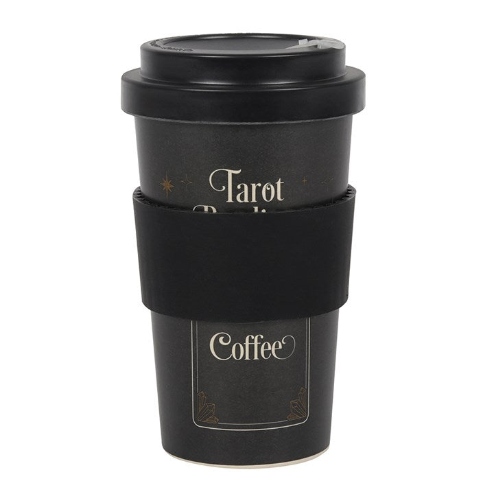 A black bamboo eco travel mug with a 'Tarot Readings' text and a coffee cup design, accompanied by a silicone sleeve and lid, placed against a white background