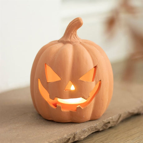 A pot jack-o-lantern tea light holder
