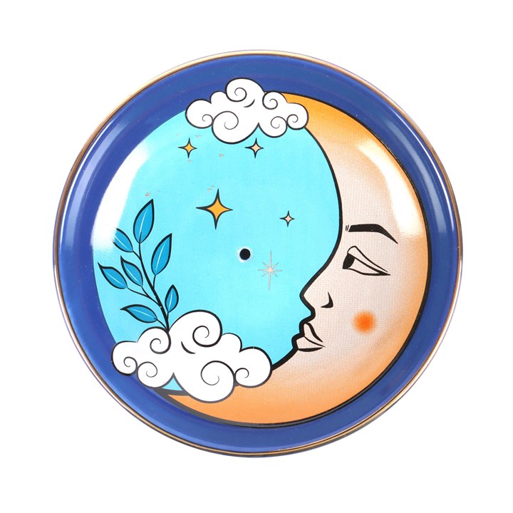 A blue ceramic incense holder with a design resembling the moon and surrounded by clouds. 