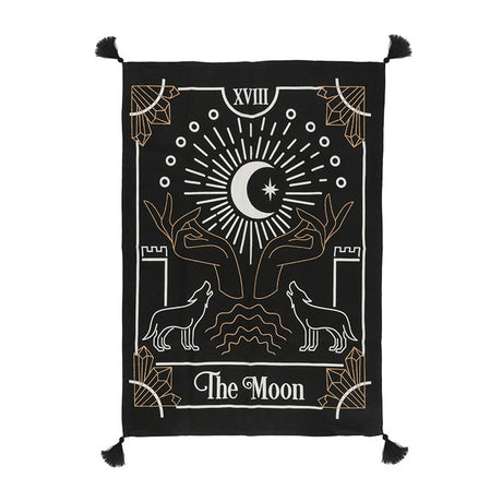 A wall tapestry featuring a mystical tarot card design with gold printed accents, corner tassels, and the text 'THE MOON' prominently displayed.