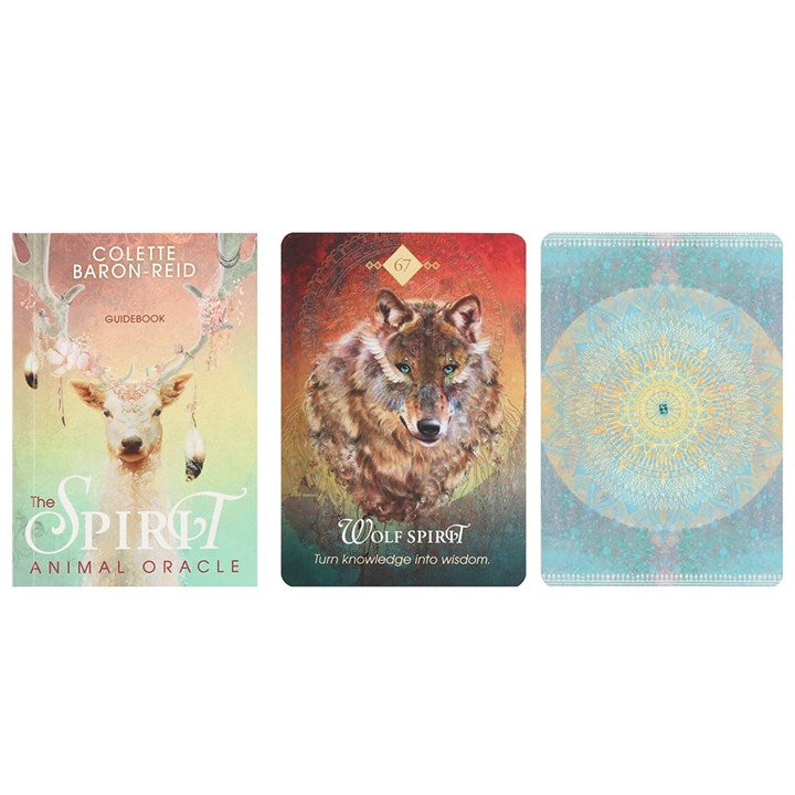 A guidebook from oracle cards by Colette Baron-Reid "The Spirit Animal Oracle" next to a "Wolf Spirit" card and a blue card.